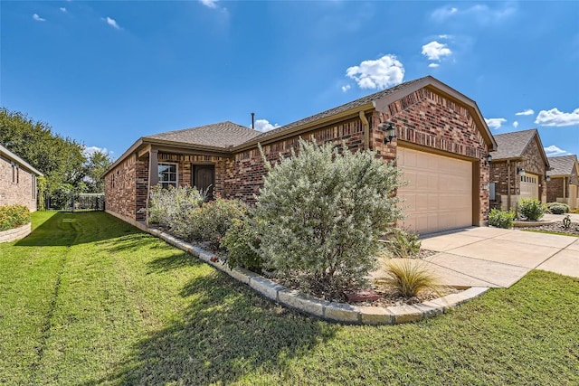 view of front of house featuring a garage, driveway, a front yard, and brick siding