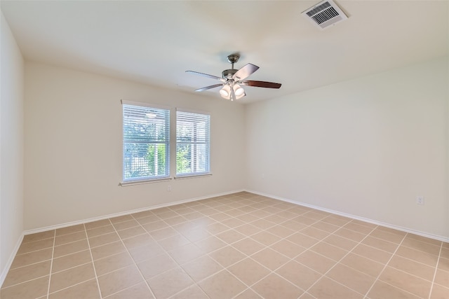 empty room with ceiling fan and light tile patterned flooring