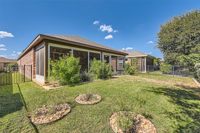 rear view of house featuring a yard