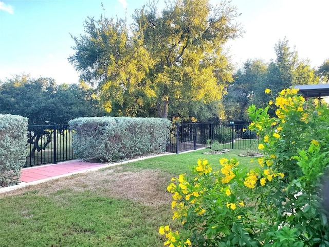 surrounding community with a yard and fence