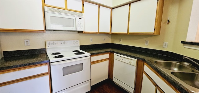 kitchen with white appliances, white cabinetry, sink, and dark wood-type flooring