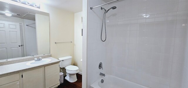 full bathroom with vanity, toilet, and tiled shower / bath