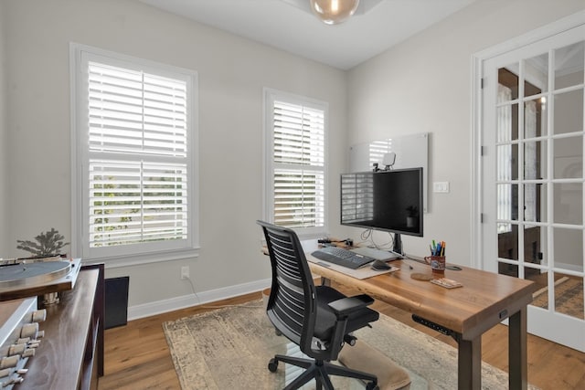 office featuring light wood-type flooring and a healthy amount of sunlight