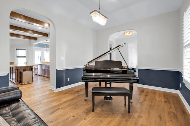 miscellaneous room featuring light hardwood / wood-style floors and beam ceiling