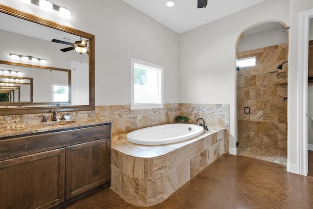 bathroom with ceiling fan, separate shower and tub, and vanity