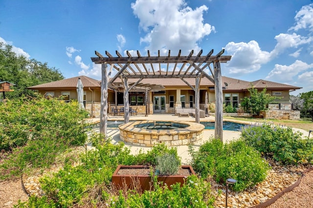 back of property with a pool with hot tub, a pergola, and a patio area