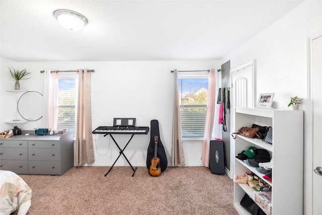 bedroom with baseboards, multiple windows, and light colored carpet