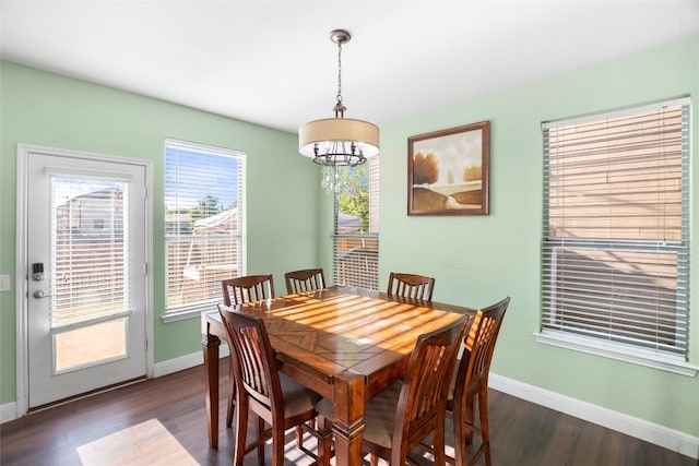 dining room with a notable chandelier, a wealth of natural light, and dark hardwood / wood-style floors