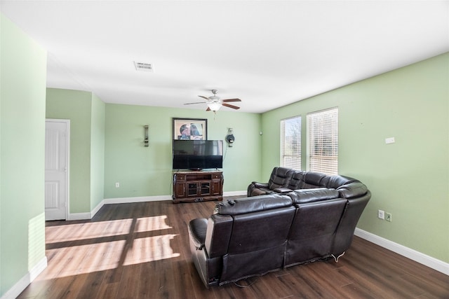 living room with dark hardwood / wood-style flooring and ceiling fan