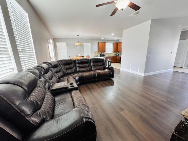 living area featuring baseboards, visible vents, a ceiling fan, wood finished floors, and recessed lighting