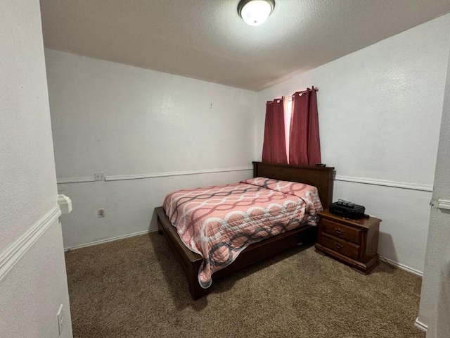 bedroom with a textured ceiling and carpet