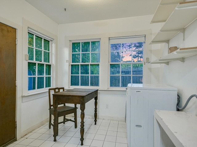 laundry area featuring washer / clothes dryer and light tile patterned floors