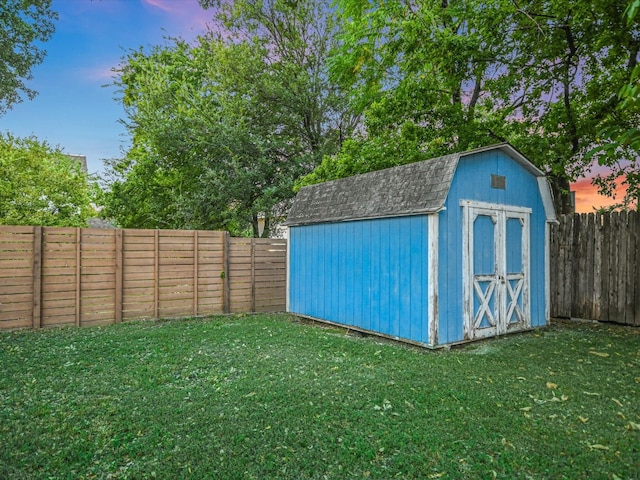 outdoor structure at dusk featuring a lawn