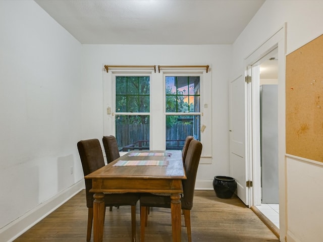 dining space with wood-type flooring