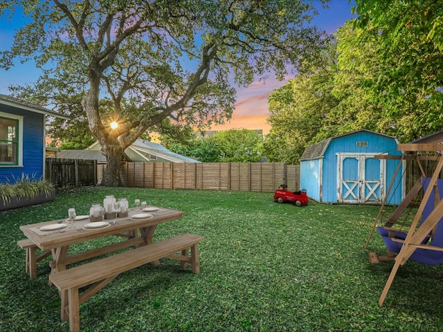 yard at dusk featuring a shed