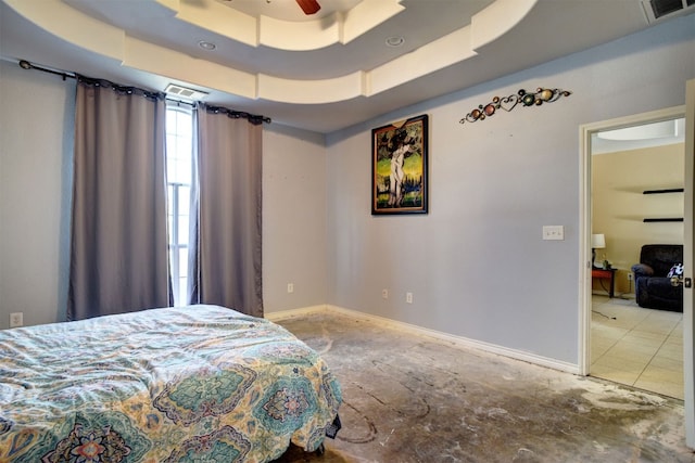 bedroom featuring a tray ceiling and ceiling fan