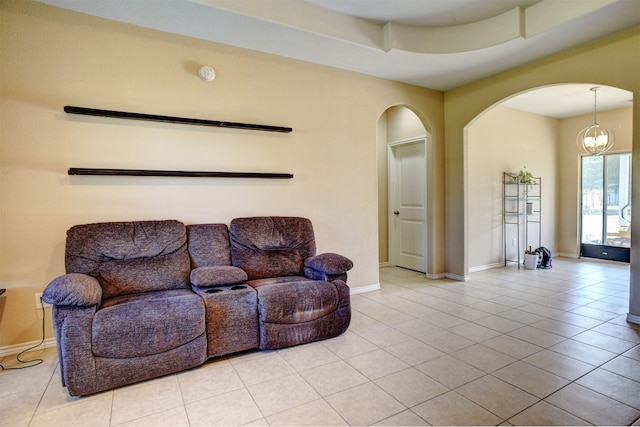 living room featuring a chandelier and light tile patterned flooring