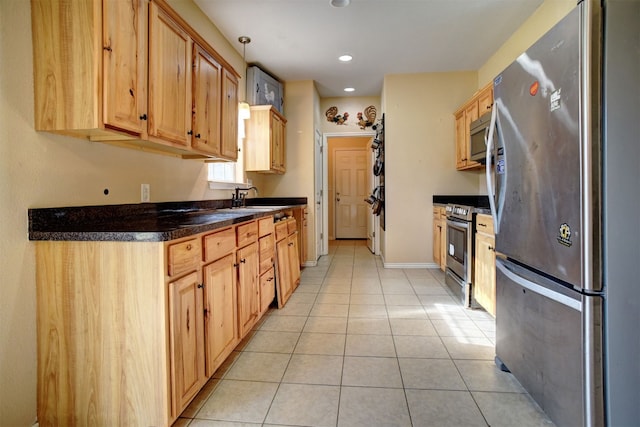 kitchen featuring light brown cabinetry, light tile patterned flooring, appliances with stainless steel finishes, and sink