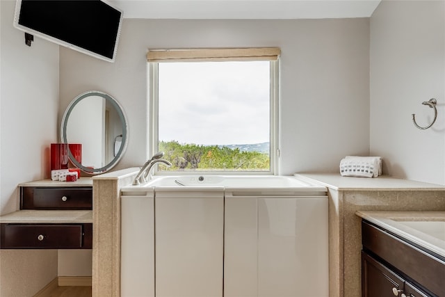 clothes washing area featuring cabinets