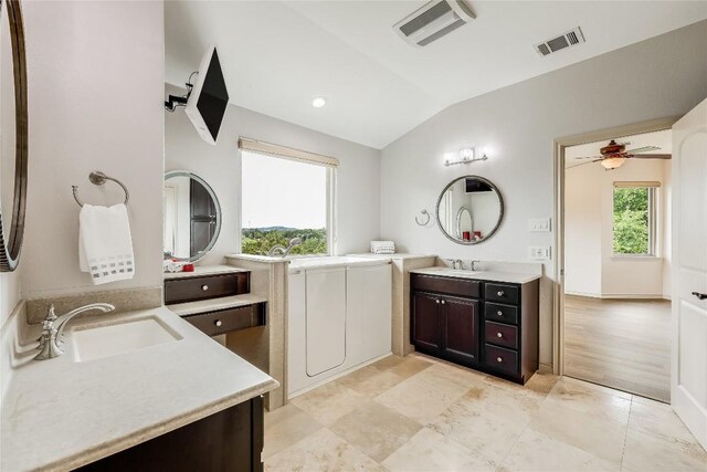 20909 Magellan Cv, Lago Vista, TX 78645 - full bathroom featuring lofted ceiling and two vanities