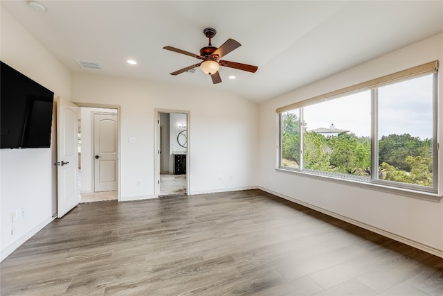 spare room featuring ceiling fan, vaulted ceiling, and hardwood / wood-style floors