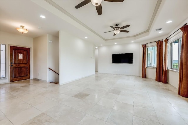 20909 Magellan Cv, Lago Vista, TX 78645 - unfurnished living room featuring ceiling fan, a raised ceiling, light tile patterned floors, recessed lighting, and baseboards