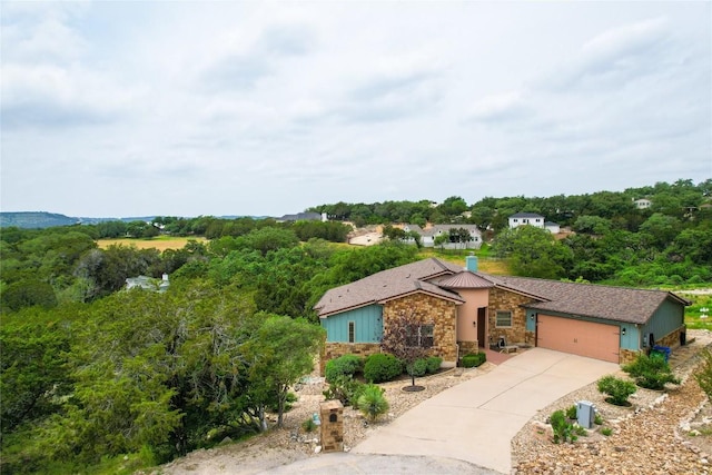 20909 Magellan Cv, Lago Vista, TX 78645 - view of front of home with stone siding, a garage, and concrete driveway
