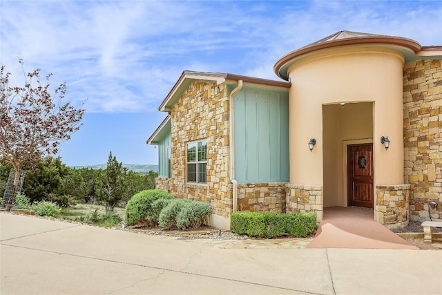 20909 Magellan Cv, Lago Vista, TX 78645 - view of exterior entry featuring stone siding and stucco siding