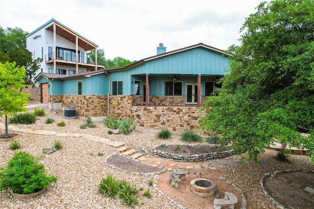20909 Magellan Cv, Lago Vista, TX 78645 - view of front of property with ceiling fan, stone siding, a balcony, and a chimney