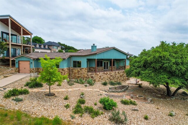 20909 Magellan Cv, Lago Vista, TX 78645 - view of front of house with stone siding, a chimney, and concrete driveway