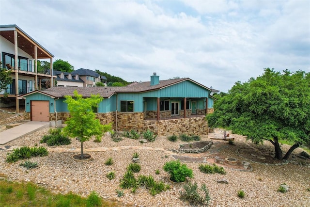 20909 Magellan Cv, Lago Vista, TX 78645 - view of front facade featuring stone siding, a chimney, and driveway