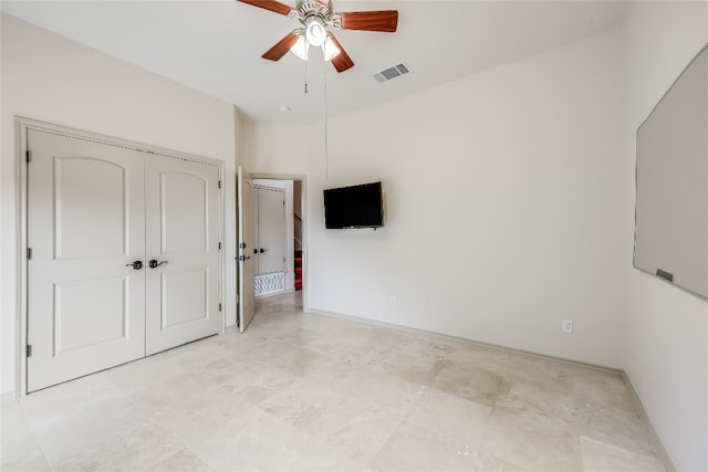 unfurnished bedroom featuring ceiling fan and a closet