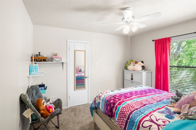 bedroom featuring a textured ceiling, carpet, and ceiling fan