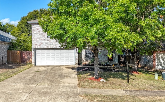 obstructed view of property with a garage