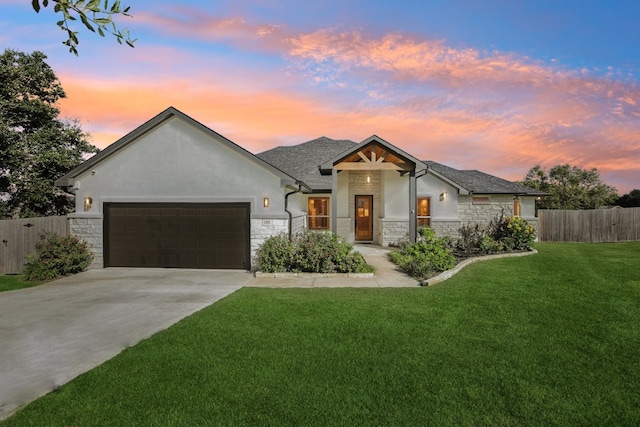 view of front of home with a lawn and a garage