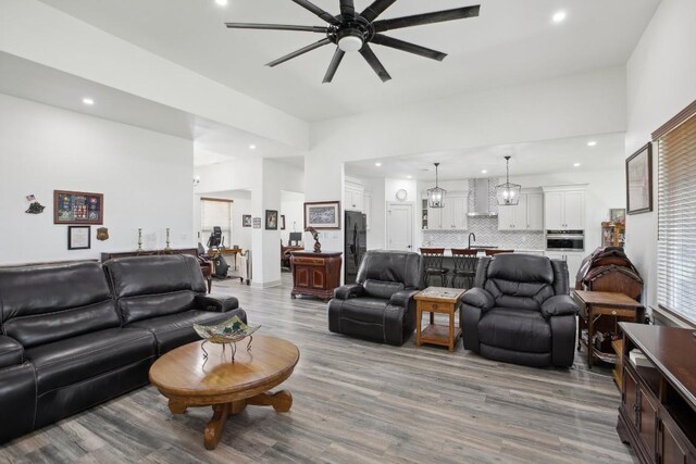 living room with ceiling fan and hardwood / wood-style flooring