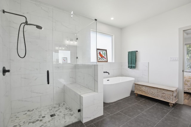 bathroom featuring independent shower and bath, tile walls, and tile patterned floors