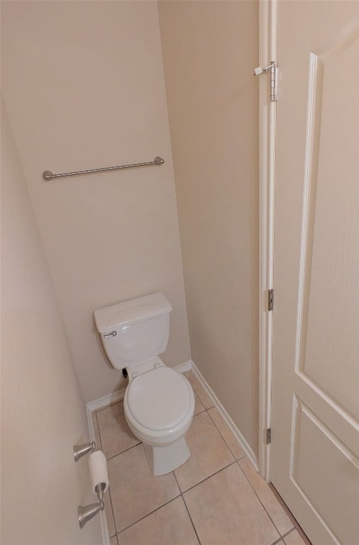 bathroom with tile patterned flooring and toilet