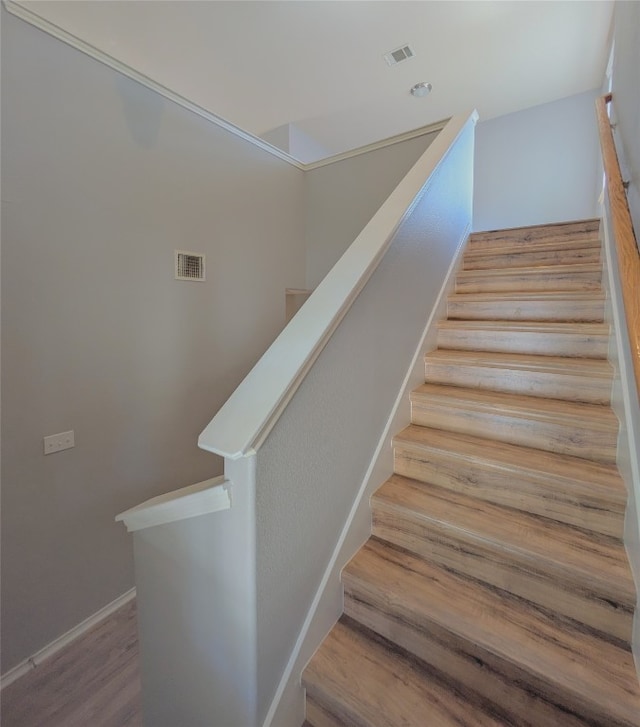 stairs with wood-type flooring