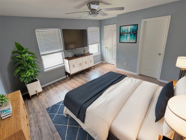 bedroom featuring ceiling fan and dark hardwood / wood-style floors