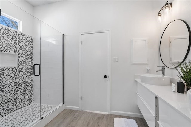 bathroom featuring wood-type flooring, vanity, and an enclosed shower