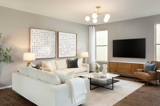 living room with a notable chandelier, plenty of natural light, and dark wood-type flooring