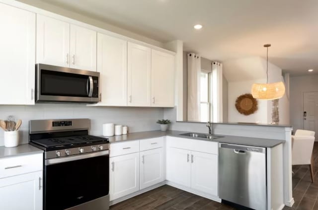 kitchen featuring white cabinetry, dark hardwood / wood-style flooring, and stainless steel appliances