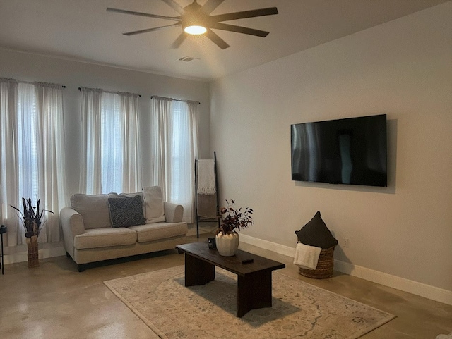 living room with concrete floors and ceiling fan