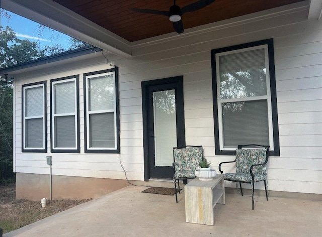 doorway to property with ceiling fan and a patio area