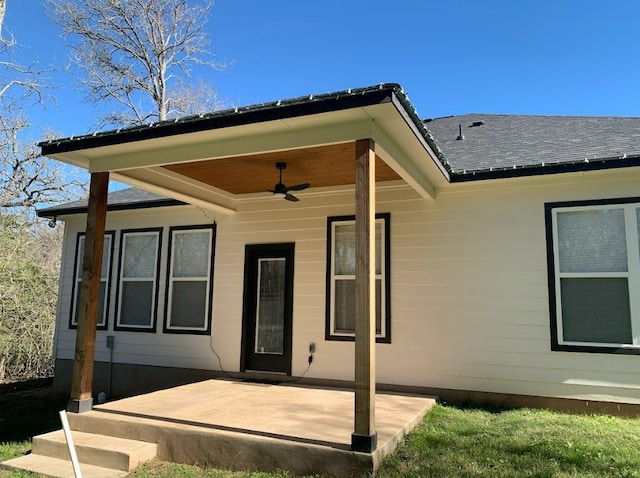 rear view of house featuring ceiling fan