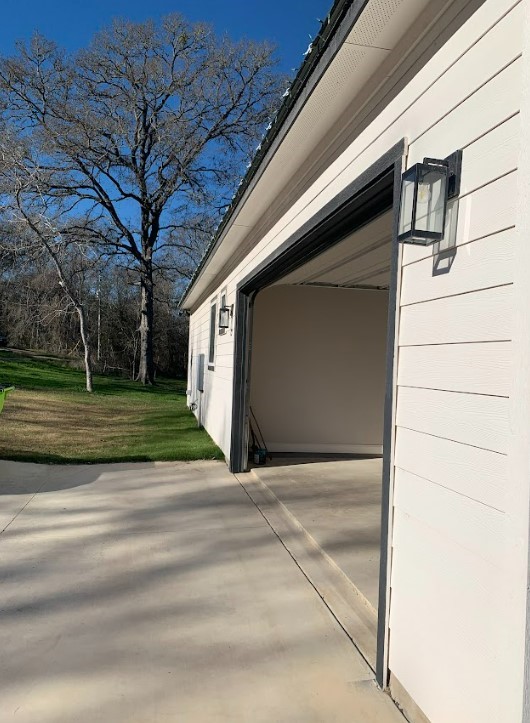 garage with a lawn