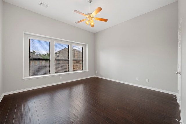 spare room featuring ceiling fan and dark hardwood / wood-style floors