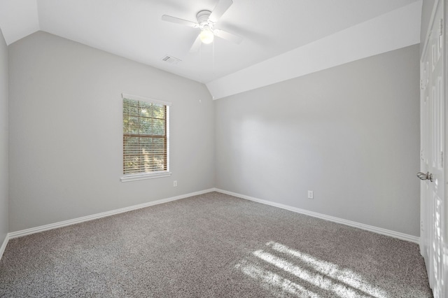 empty room with carpet, lofted ceiling, and ceiling fan