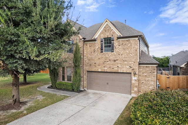 view of front of property with a front yard and a garage